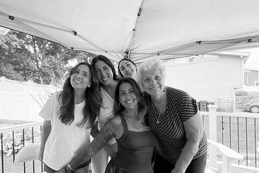 Group of guests smiling together in a black-and-white photo