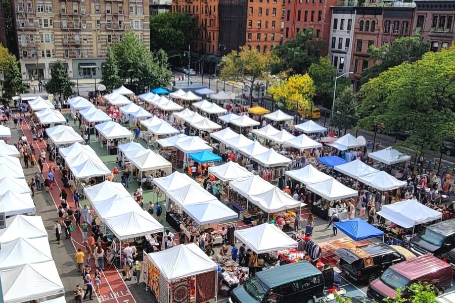 Outdoor pop-up market filled with rows of white vendor tents